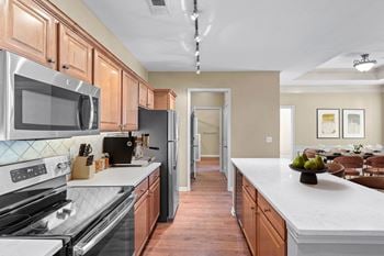A kitchen with updated stainless steel appliances and a kitchen island.